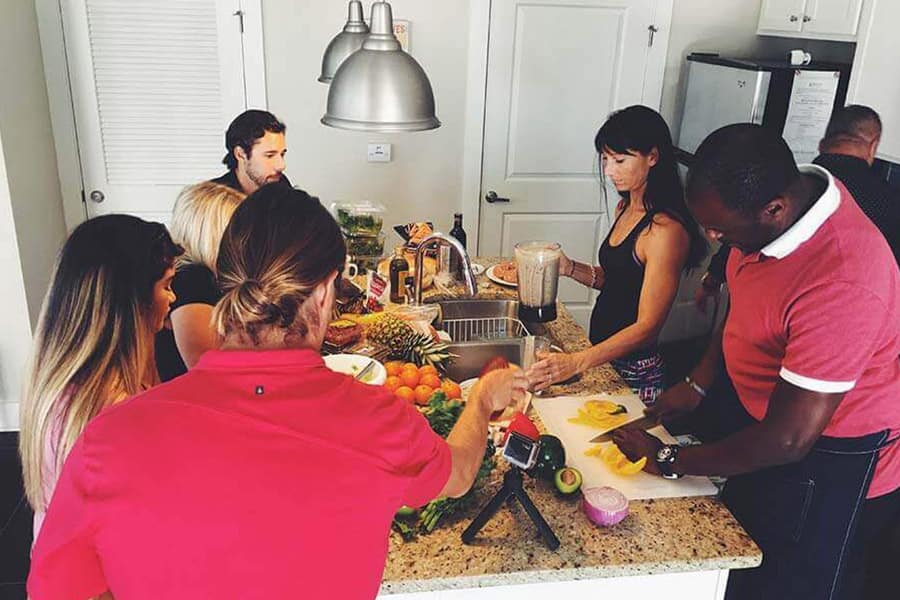 Patients in a drug rehab house working together to prepare dinner