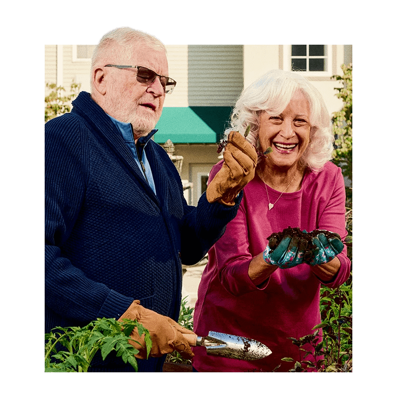 Seniors smiling while gardening