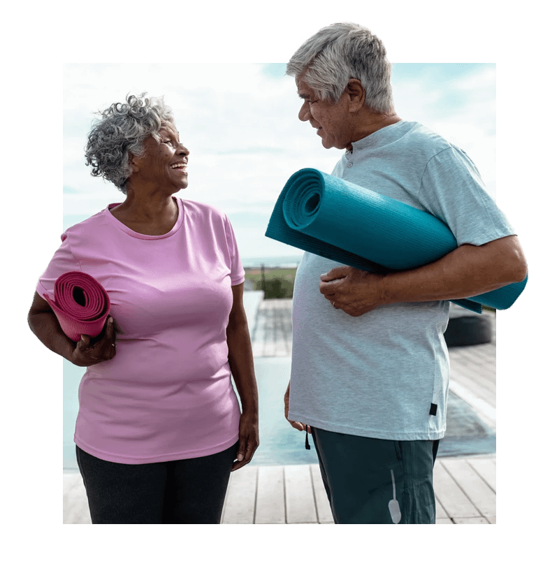 Seniors holding yoga mats