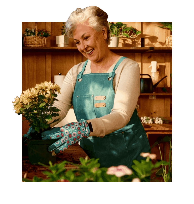 Senior holding flowers while gardening